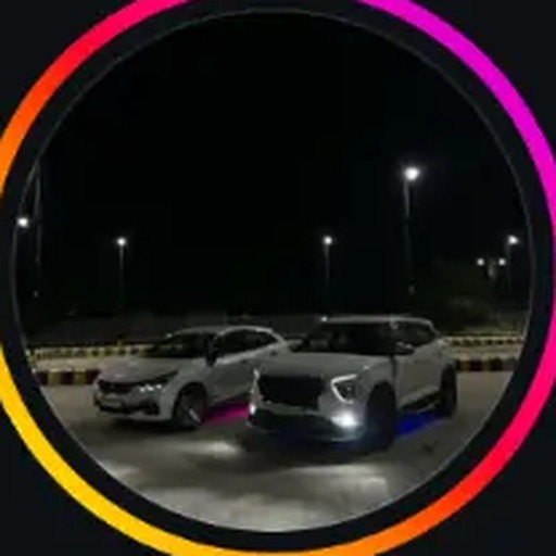 OG Whipz signature night shot of two cars under floodlights